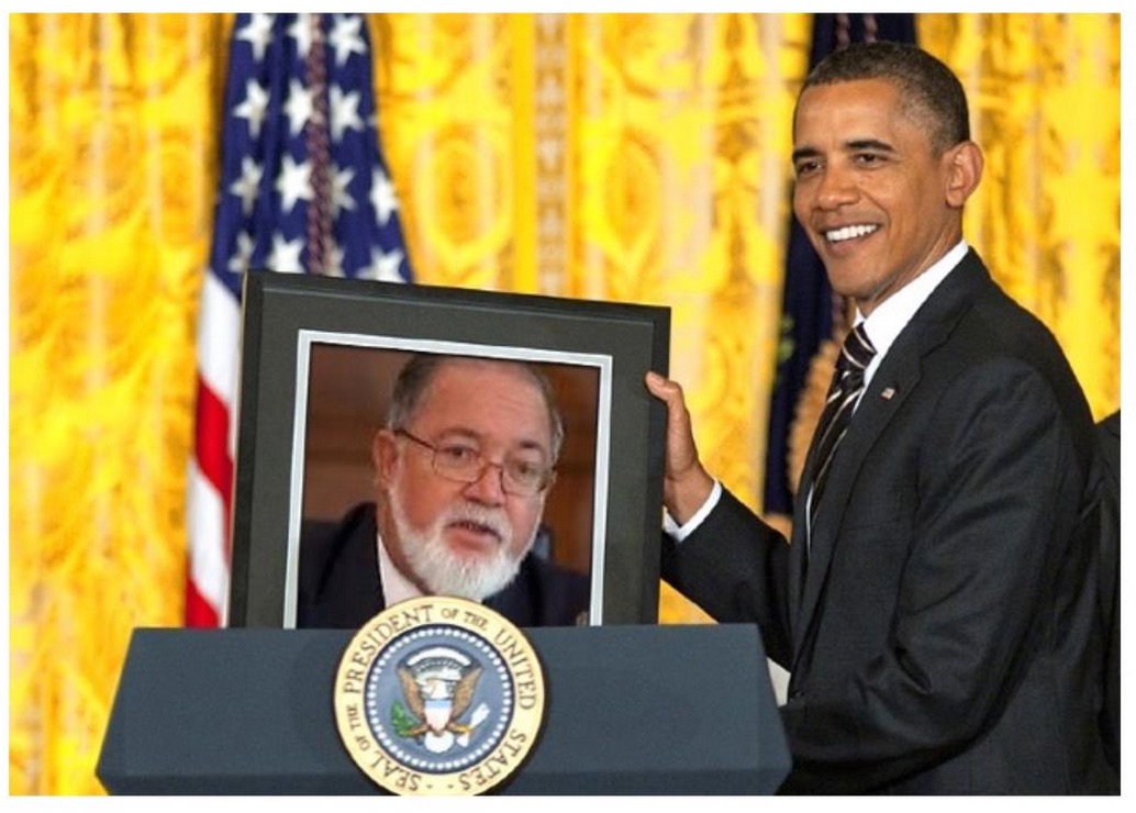 President Obama with Photo of Sir James Mancham PhotoL Courtesy of Sir James